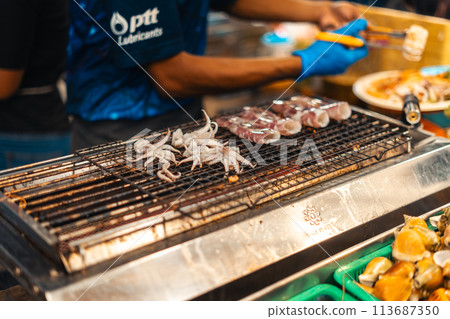 Squid grilled on the grill at Street Food Market Squid grilled on the grill at Street Food Market 113687350