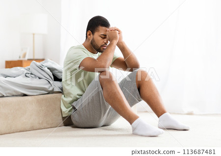 Man holding head, feeling sad or stressed 113687481