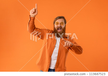 redhaired bearded man wearing sunglasses dances with cool vibes, studio 113687523