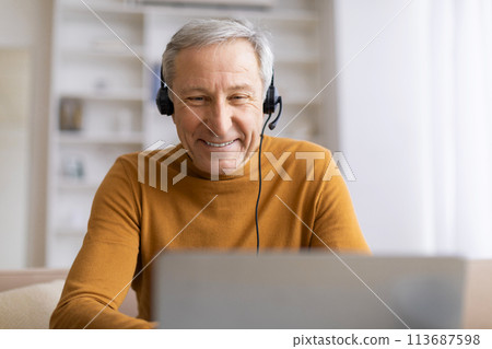 Elderly man enjoying music on headphones Elderly man enjoying music on headphones 113687598