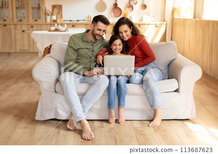 Family with laptop enjoying time together at home Family with laptop enjoying time together at home 113687623