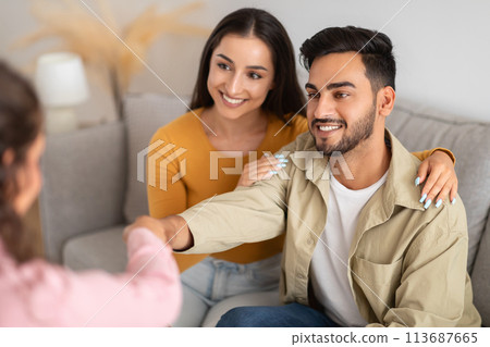 Couple shaking hands with counselor at clinic Couple shaking hands with counselor at clinic 113687665