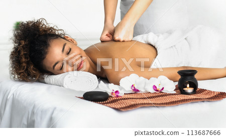 Woman enjoying aroma massage in spa salon 113687666