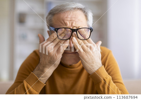 Man holding book, seeming deep in thought Man holding book, seeming deep in thought 113687694