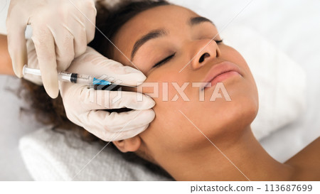 Beautiful african american woman get beauty injection at cosmetologist Beautiful african american woman get beauty injection at cosmetologist 113687699