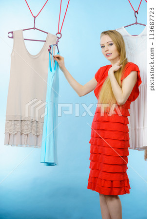 Woman choosing clothes in shop Woman choosing clothes in shop 113687723