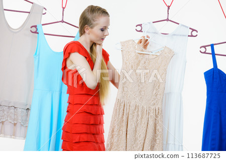 Woman choosing clothes in shop Woman choosing clothes in shop 113687725