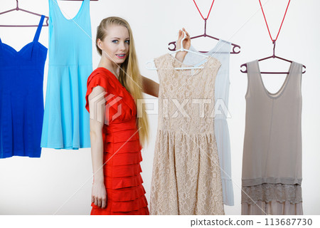 Woman choosing clothes in shop 113687730