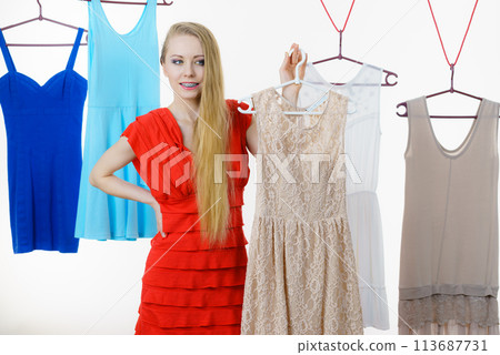 Woman choosing clothes in shop Woman choosing clothes in shop 113687731