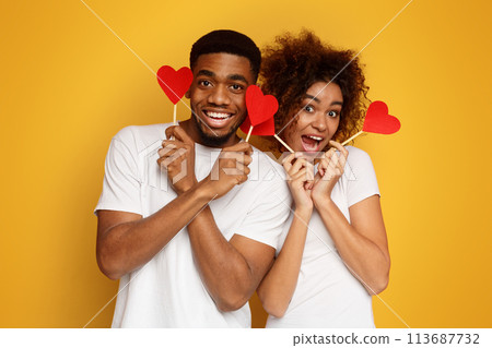 Happy african-american couple holding red paper hearts 113687732