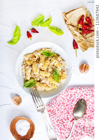 boiled pasta with minced meat and basil 113687842