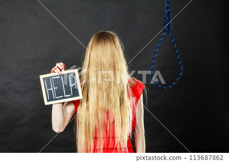 Suicidal woman holding help sign next to rope 113687862