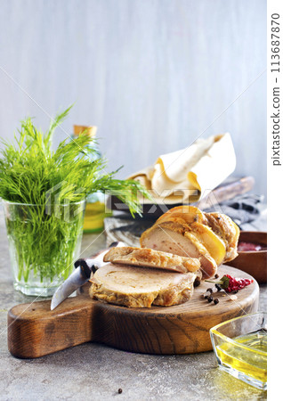 baked meat roll with spice on wooden board 113687870