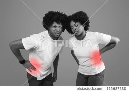 African america man and woman in pain touching abdominal side African america man and woman in pain touching abdominal side 113687888