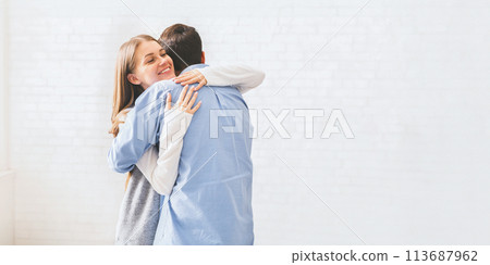Happy spouses cuddling each other after group meeting with relationship therapist. 113687962