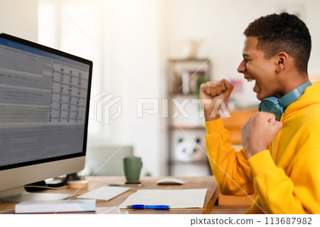 Focused individual coughing while working on computer 113687982