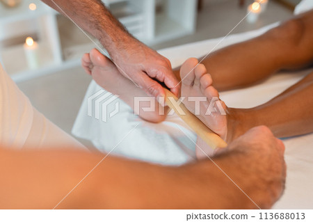 Therapeutic foot massage by a professional in spa 113688013