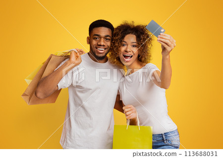 Young black couple with shopping bags and credit card Young black couple with shopping bags and credit card 113688031