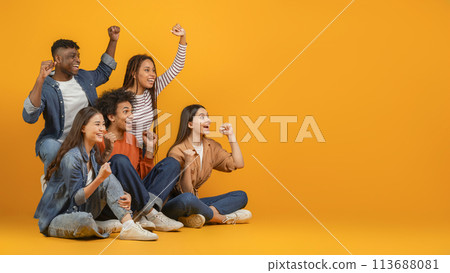 Group of friends cheering and celebrating on orange background Group of friends cheering and celebrating on orange background 113688081