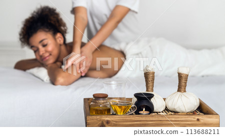 African American lady receiving a spa massage 113688211