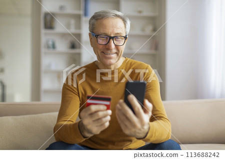 Mature man with phone and credit card Mature man with phone and credit card 113688242