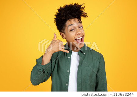 Cheerful black guy mimicking phone call 113688244