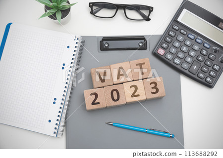 A wooden block with the word VAT 2023 113688292