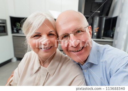 Smiling senior couple taking selfie at home 113688340