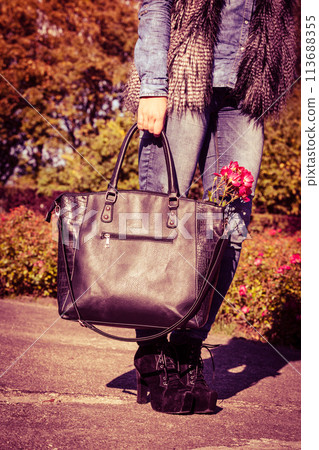 Woman spends time in park outdoor. 113688355