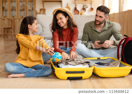 Family bonding and packing for a holiday together 113688612