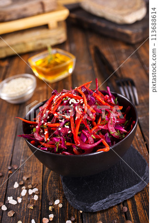 Fresh vegetable salad with sauerkraut cabbage, grated carrots and beetroots Fresh vegetable salad with sauerkraut cabbage, grated carrots and beetroots 113688614
