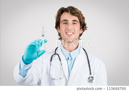 Happy male doctor holding syringe, ready to vaccinate 113688700