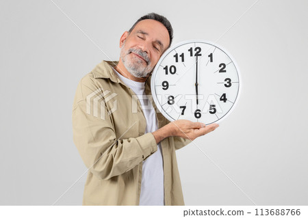 Senior man with clock symbolizing time concept 113688766