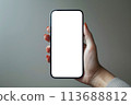 Female hand holding black smartphone with blank transparent screen for business infographic web site design app 113688812