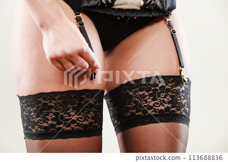 Woman wear garter belt and stockings. 113688836