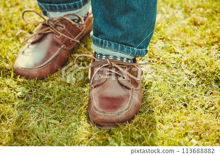 Male footwear in grass. Male footwear in grass. 113688882