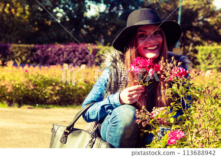 Young lady relaxing in garden Young lady relaxing in garden 113688942