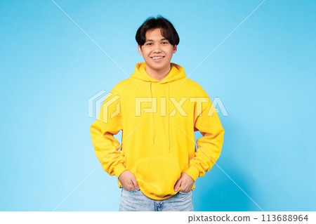 Casual young guy in vibrant yellow hoodie 113688964