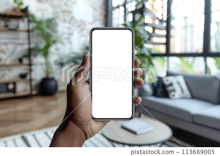 Augmented reality in interior design mockup. Close-up view of a black hand holding smartphone with transparent blank screen, ideal for digital AR design Augmented reality in interior design mockup. Close-up view of a black hand holding smartphone with transparent blank screen, ideal for digital AR design 113689005
