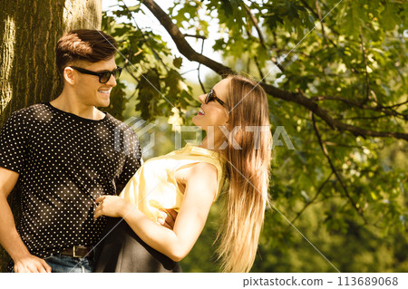 Couple hugging under tree. Couple hugging under tree. 113689068