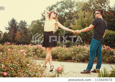 Cheerful girl holding hands in park. 113689078