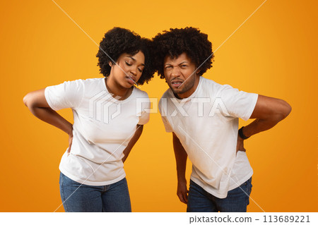 Unhappy millennial african american spouses suffer from back pain Unhappy millennial african american spouses suffer from back pain 113689221