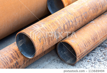 Metal pipes covered with rust at the construction site Metal pipes covered with rust at the construction site 113689494