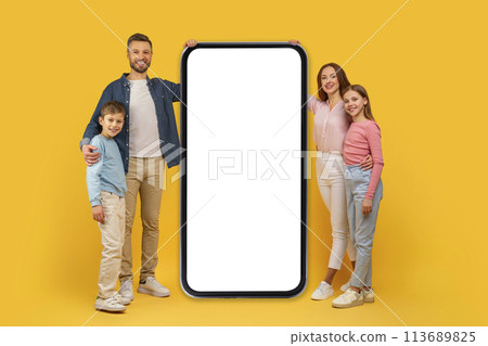 Family with large smartphone mockup on yellow background 113689825