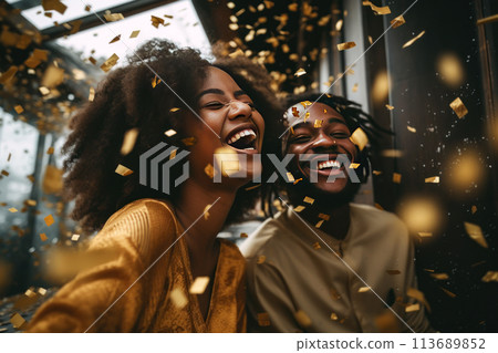 Happy African couple laughs under a rain of golden confetti Happy African couple laughs under a rain of golden confetti 113689852