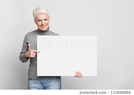 Senior woman holding a blank white board Senior woman holding a blank white board 113689966