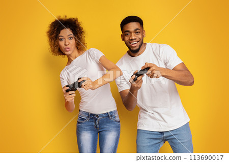 Emotional couple playing video game with joysticks Emotional couple playing video game with joysticks 113690017