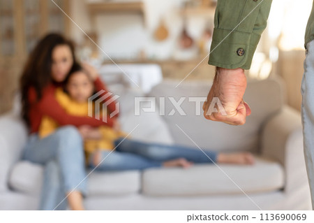 Man holding hand out to sitting woman and girl 113690069