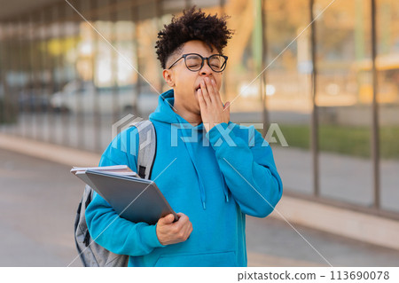 Young student with books at university campus Young student with books at university campus 113690078