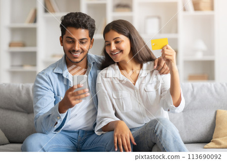 Indian spouses shopping online with credit card and smartphone 113690092